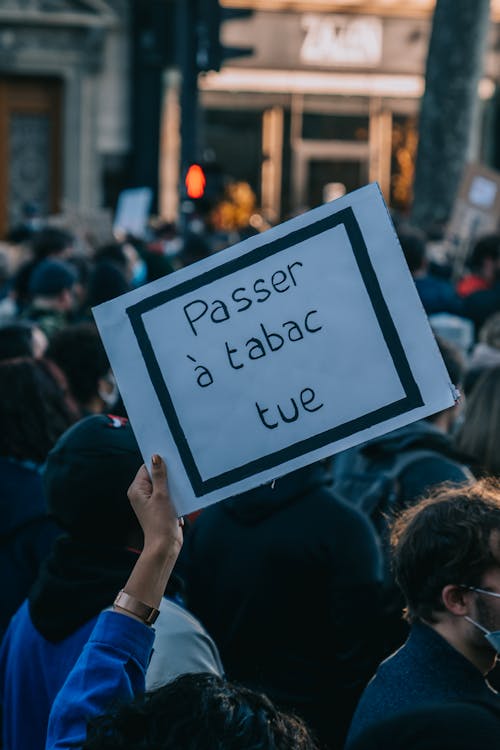 Free Protesters hold signs in a Paris street demonstration against violence. Stock Photo