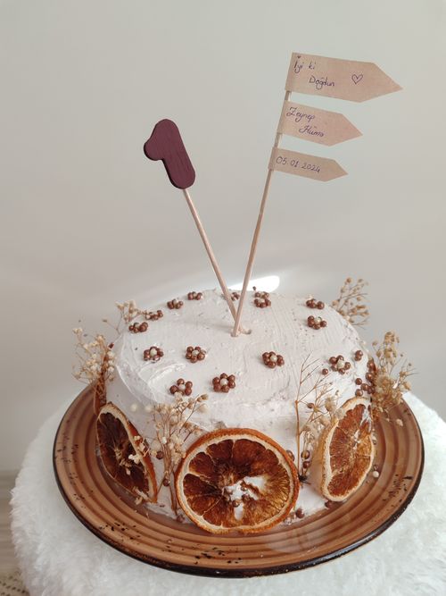 Free A handcrafted cake adorned with dried orange slices and rustic decorations, perfect for special occasions. Stock Photo