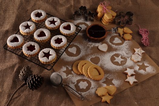 A cozy scene of homemade cookies with jam filling, perfect for holiday baking inspiration.