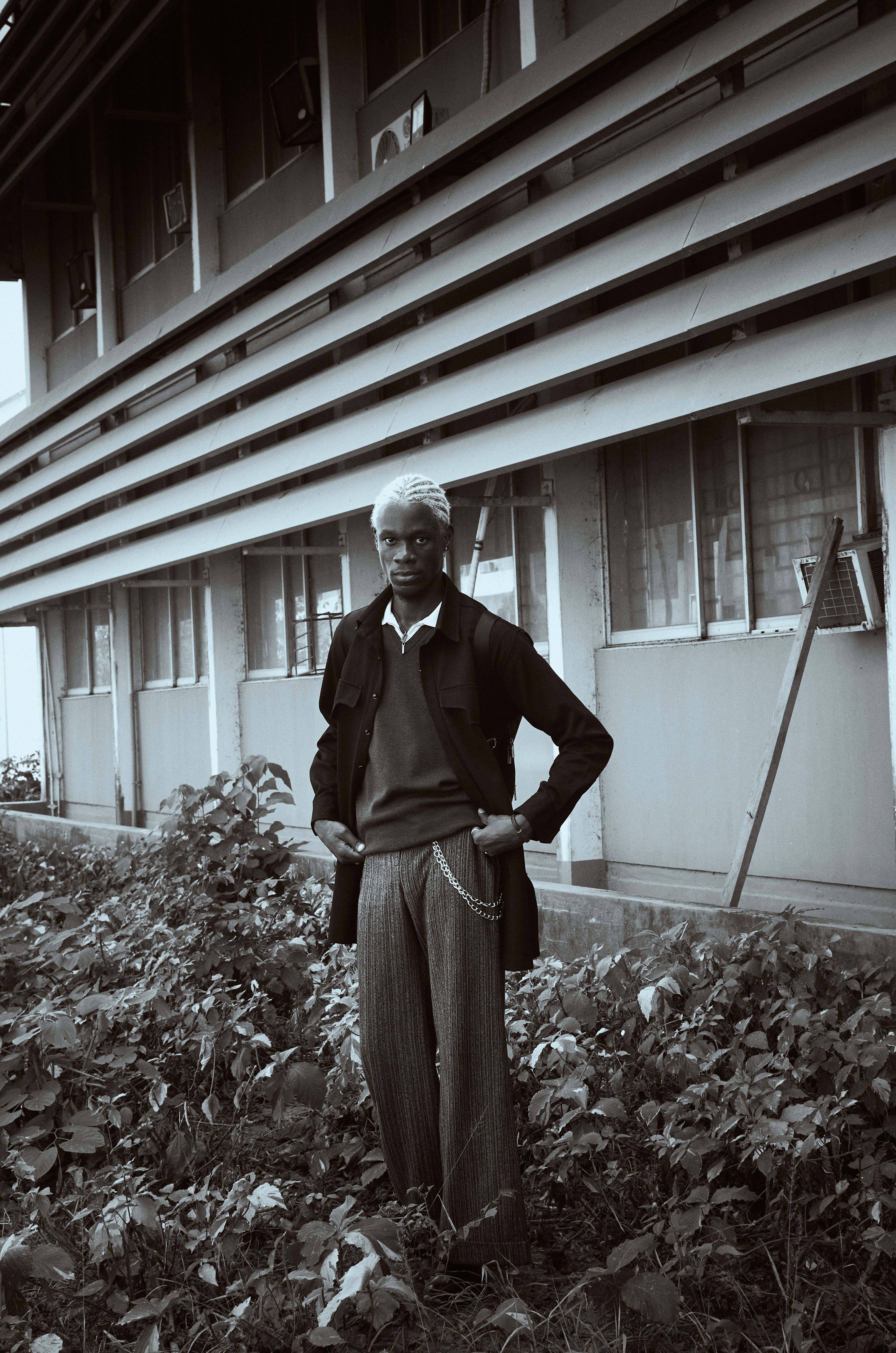 Stylish Man Standing by Industrial Building · Free Stock Photo