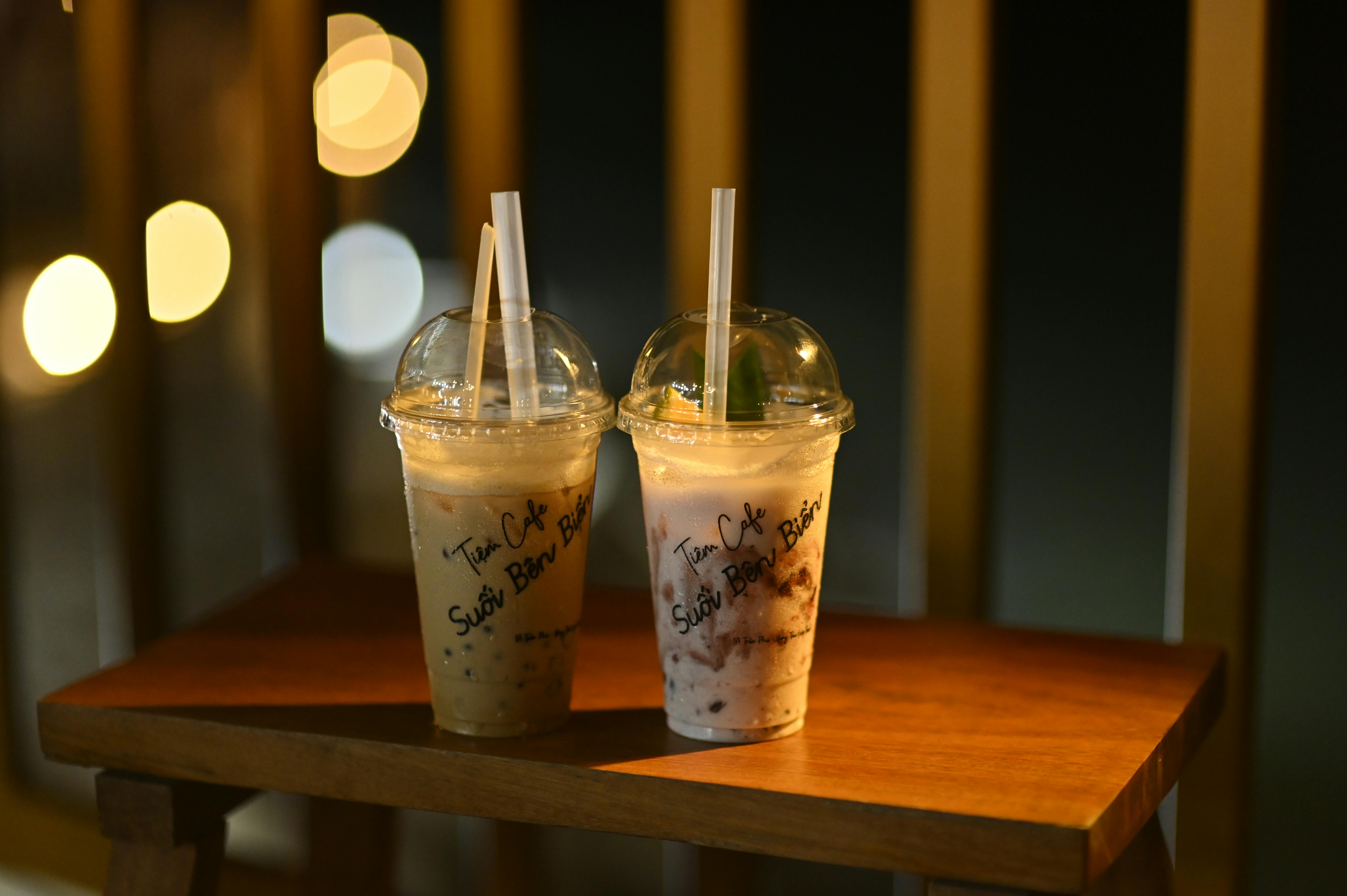 Coffee drinks on a wooden table at night in Vũng Tàu, Vietnam.