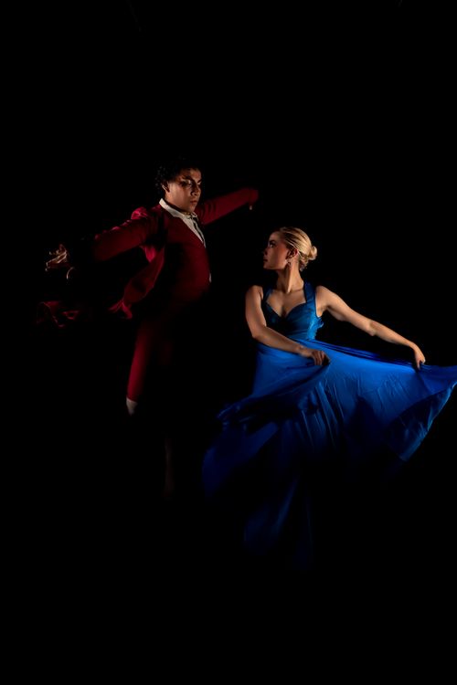 Free A graceful dance performance captured in vivid colors under dramatic lighting. Stock Photo