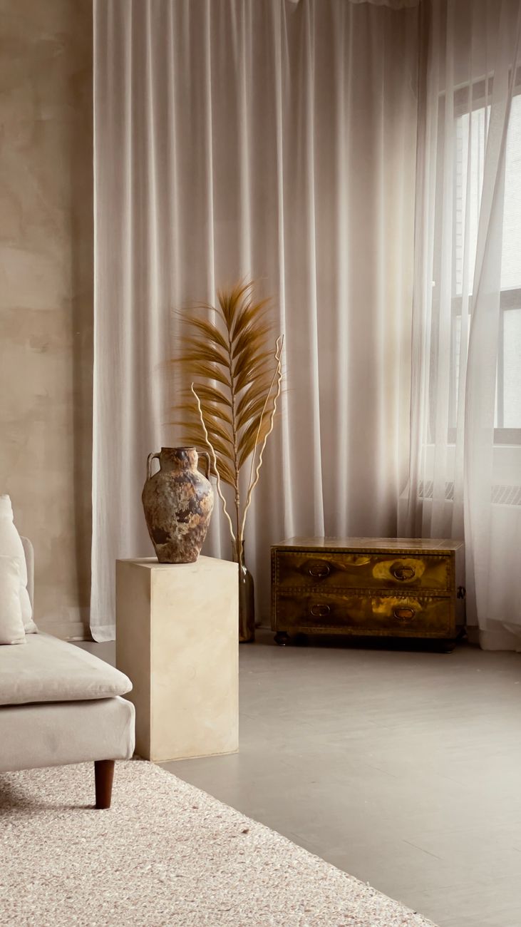 Elegant wabi sabi styled room with neutral decor featuring a metal vase and tall curtains in soft lighting.. pexels, elegant,