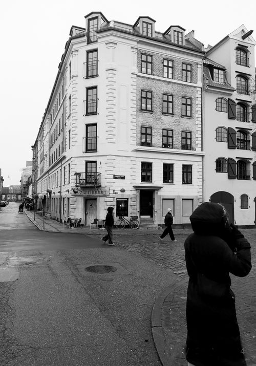 Free Street scene in Copenhagen featuring classic architecture and pedestrians. Stock Photo