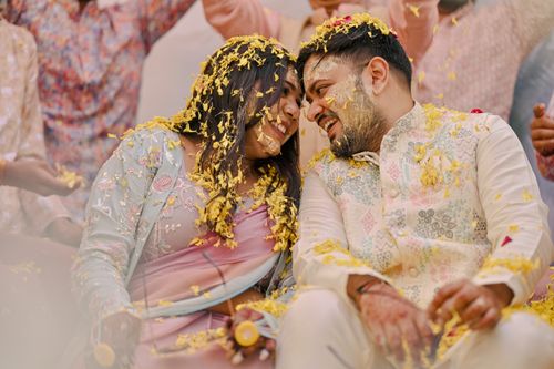 Free Happy couple celebrating Indian wedding with flowers and joy. Stock Photo