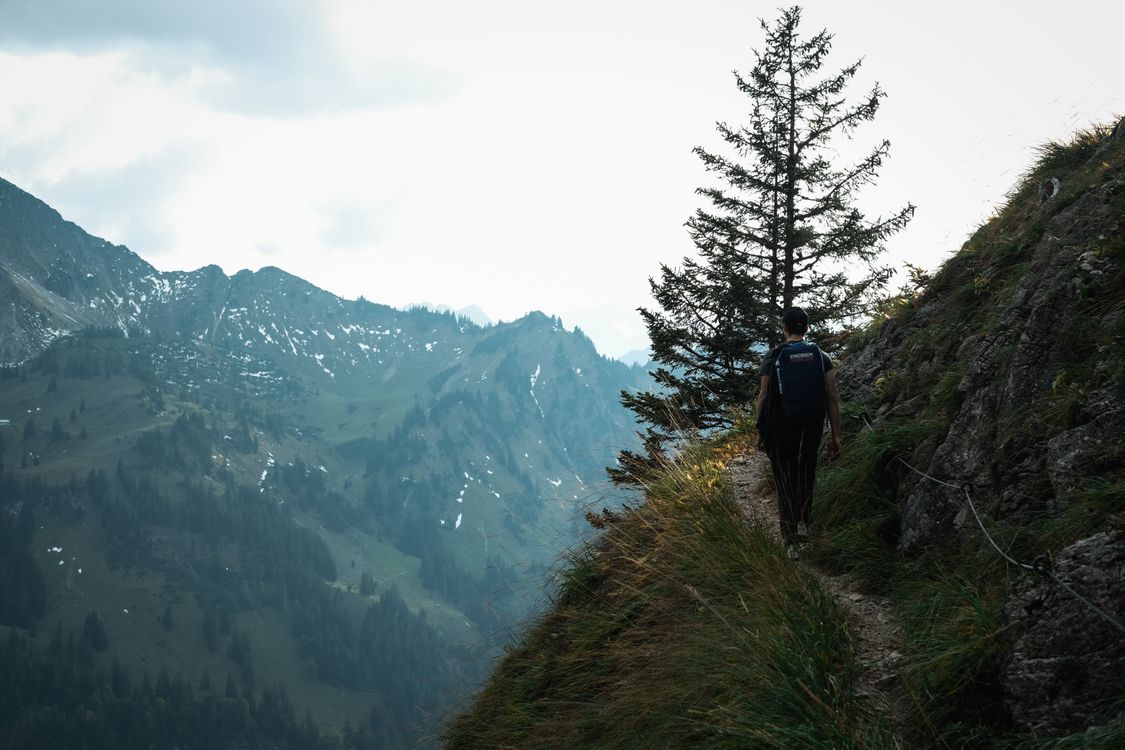 Hiker Exploring Trail in Scenic Mountain Range · Free Stock Photo
