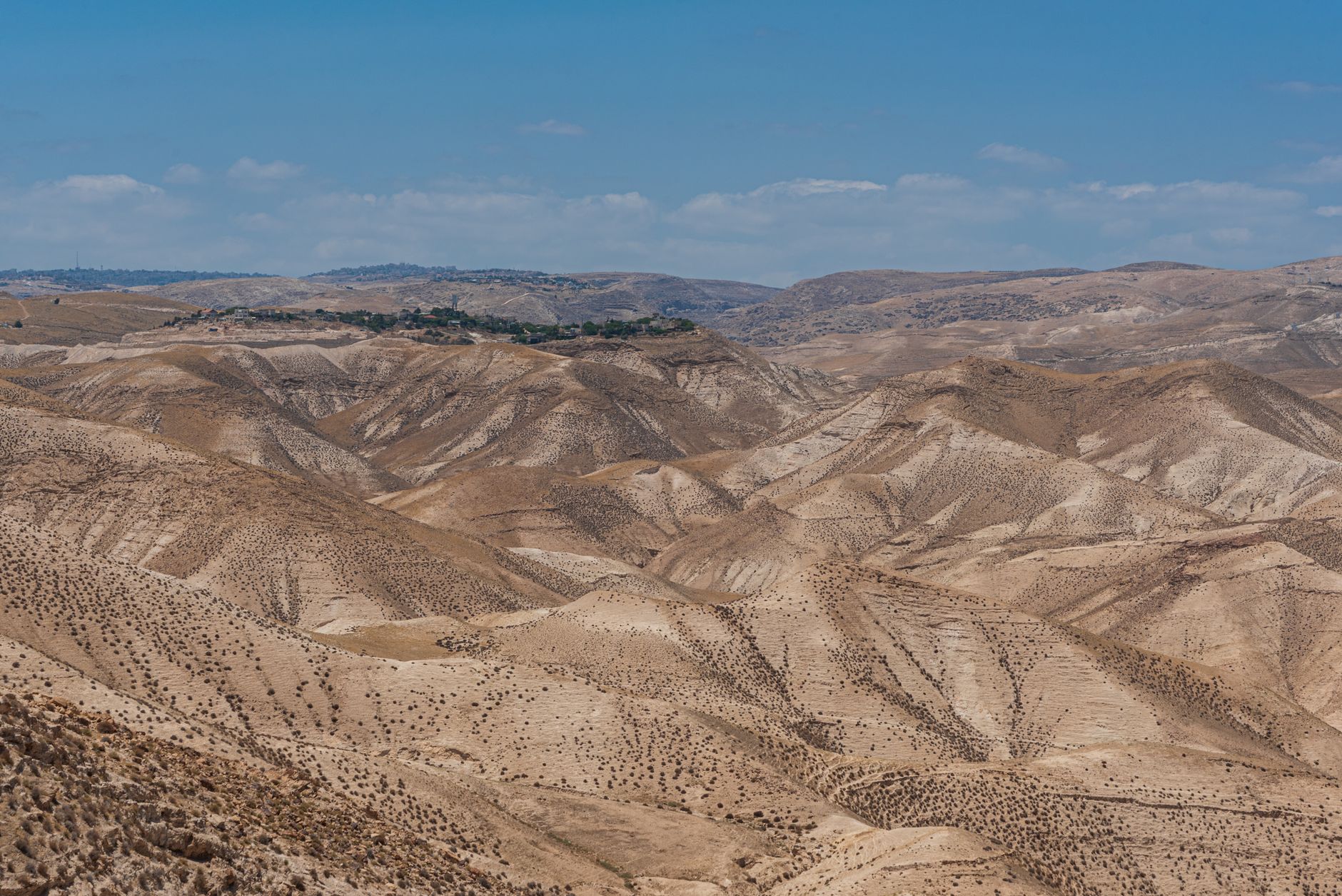 Breathtaking view of Israel's arid desert terrain with rolling hills under a clear sky.