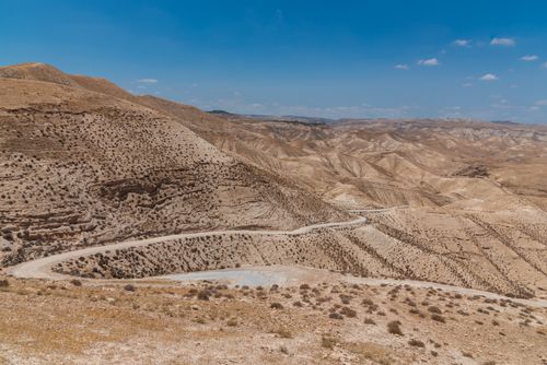 Free Rugged desert landscape in Israel, showcasing arid hills under a clear blue sky. Stock Photo