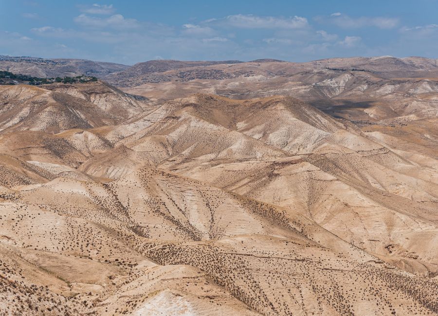 Scenic view of arid desert hills under a clear blue sky in Israel.