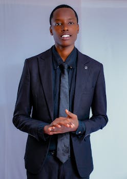Portrait of a confident businessman in a dark suit on white background.