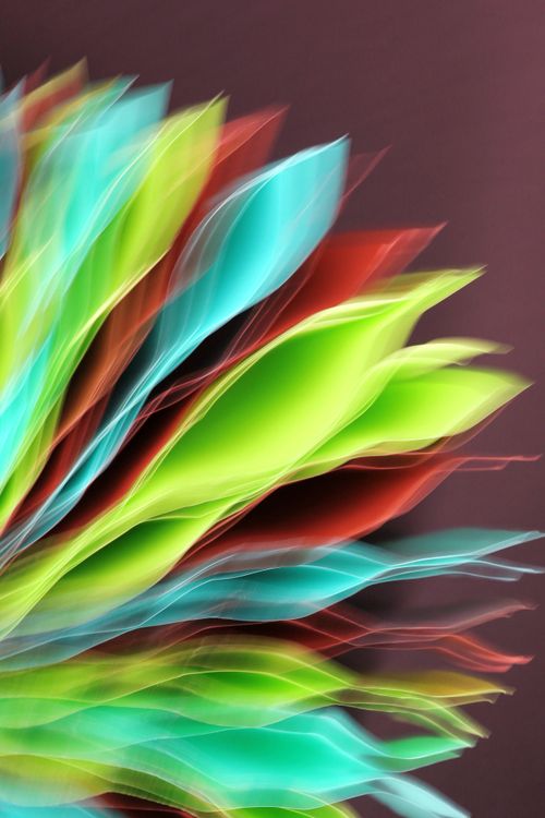 Free Vibrant abstract art featuring colorful leaf-like shapes in motion, evoking a sense of dynamic energy. Stock Photo