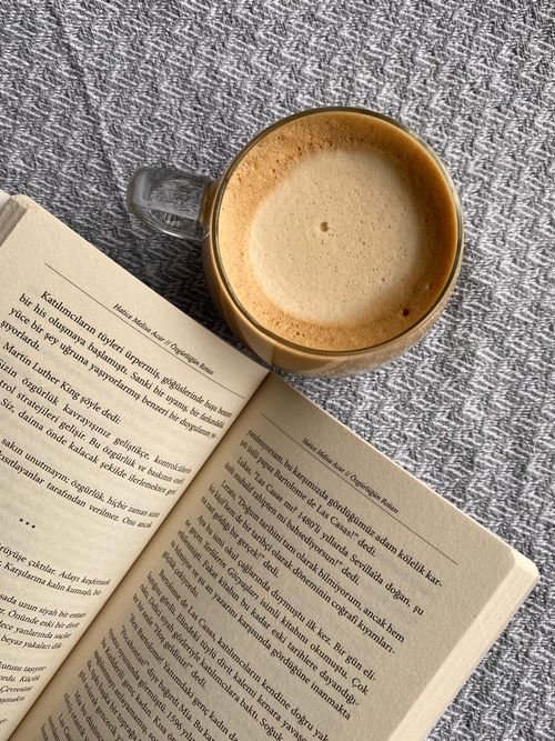 Free Open book and coffee cup on a textured background, perfect for a relaxing moment. Stock Photo