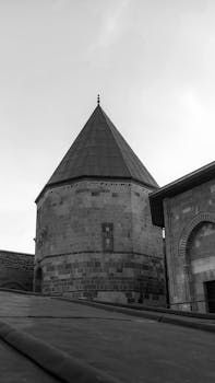 Black and white photo of a historic stone structure in Konya, Türkiye, showcasing classical architecture.