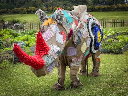 Free Recycled art rhino sculpture showcasing creative use of materials outdoors. Stock Photo