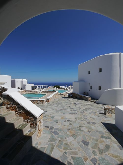 Free Beautiful Cycladic architecture with a sea view under clear blue skies. Stock Photo