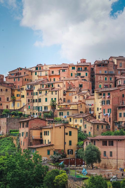 Free Charming hillside view of the colorful historic buildings in Siena, Tuscany, Italy. Stock Photo