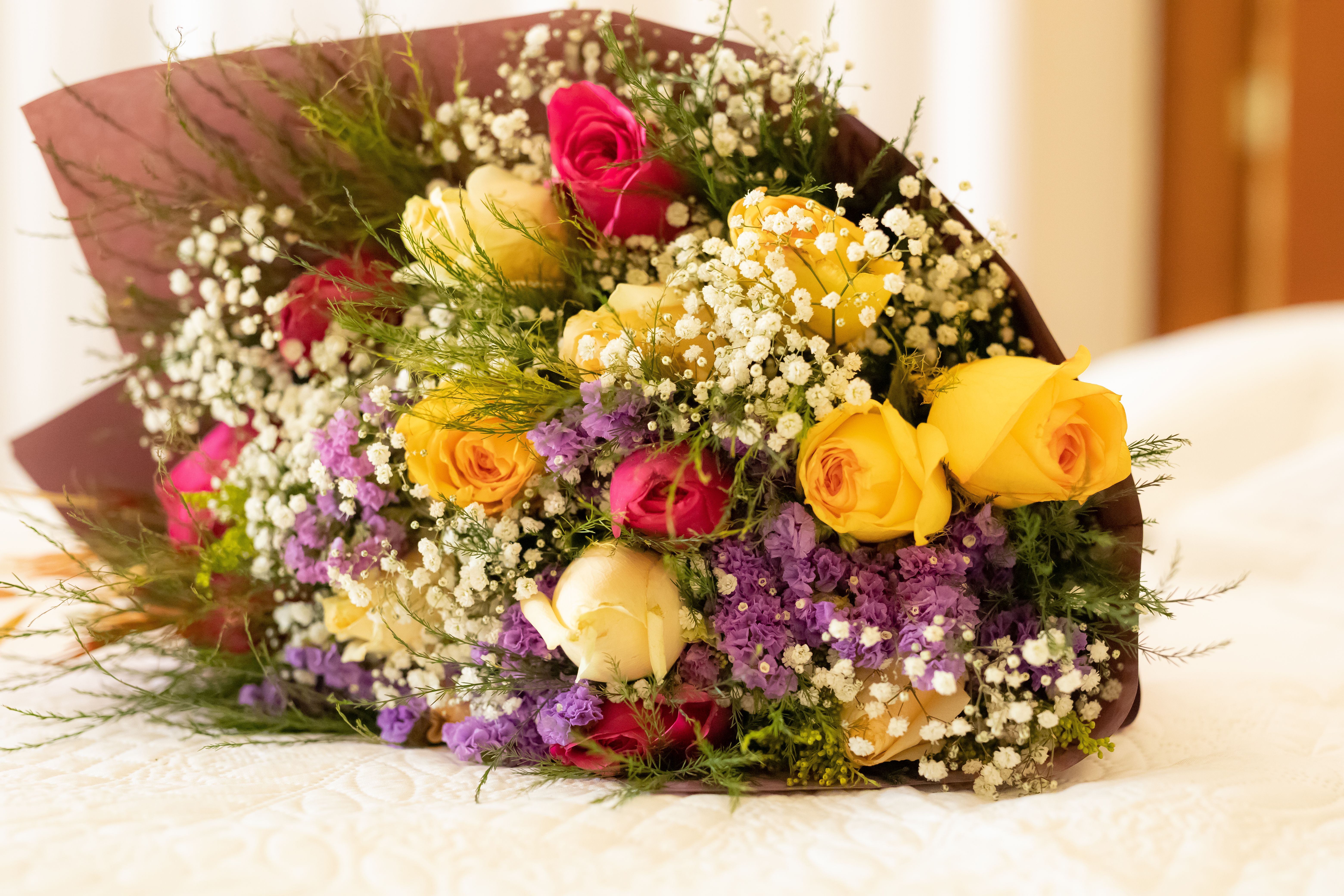 Lush rose bouquet with mixed colors wrapped in kraft paper