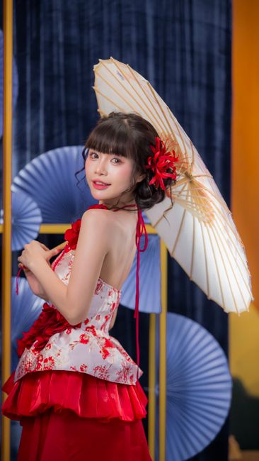 Portrait of a Vietnamese woman celebrating Tết in traditional attire with an umbrella, representing cultural elegance.