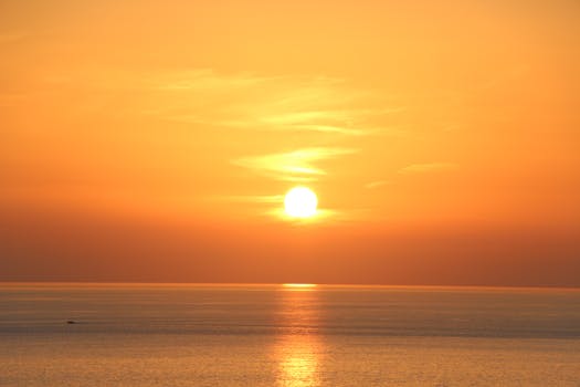 Beautiful orange sunset over the Ligurian Sea in Italy, highlighting serene ocean scenery.