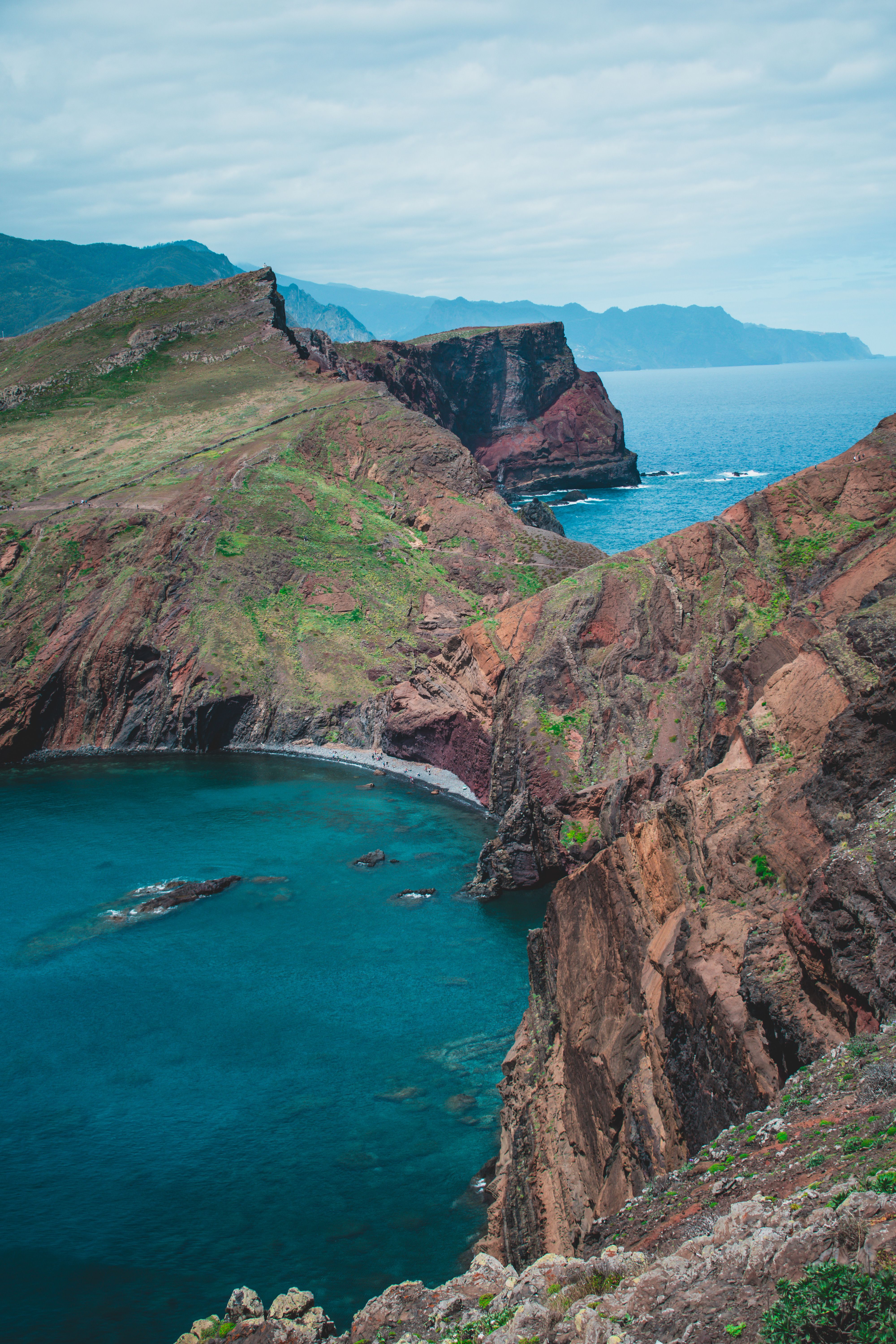 Breathtaking view of rugged coastal cliffs overlooking the deep blue ocean waters.