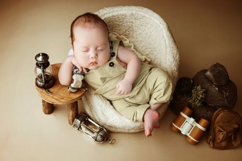 Free A peaceful baby sleeping in a soft basket surrounded by decor. Stock Photo