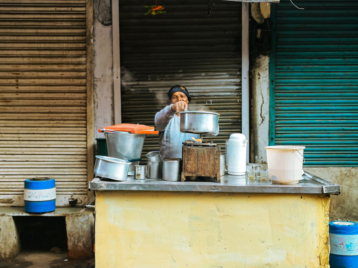 Street-food vendor cooking a meal at a market stall