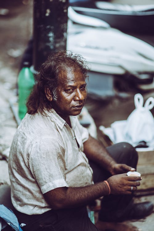 Man Sitting At The Street