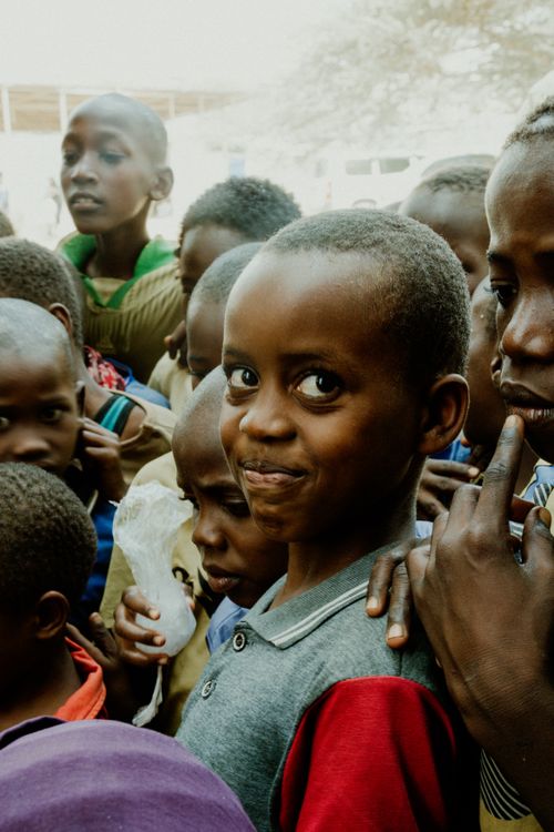 Free A lively group of smiling children gathered outdoors, exuding warmth and joy. Stock Photo