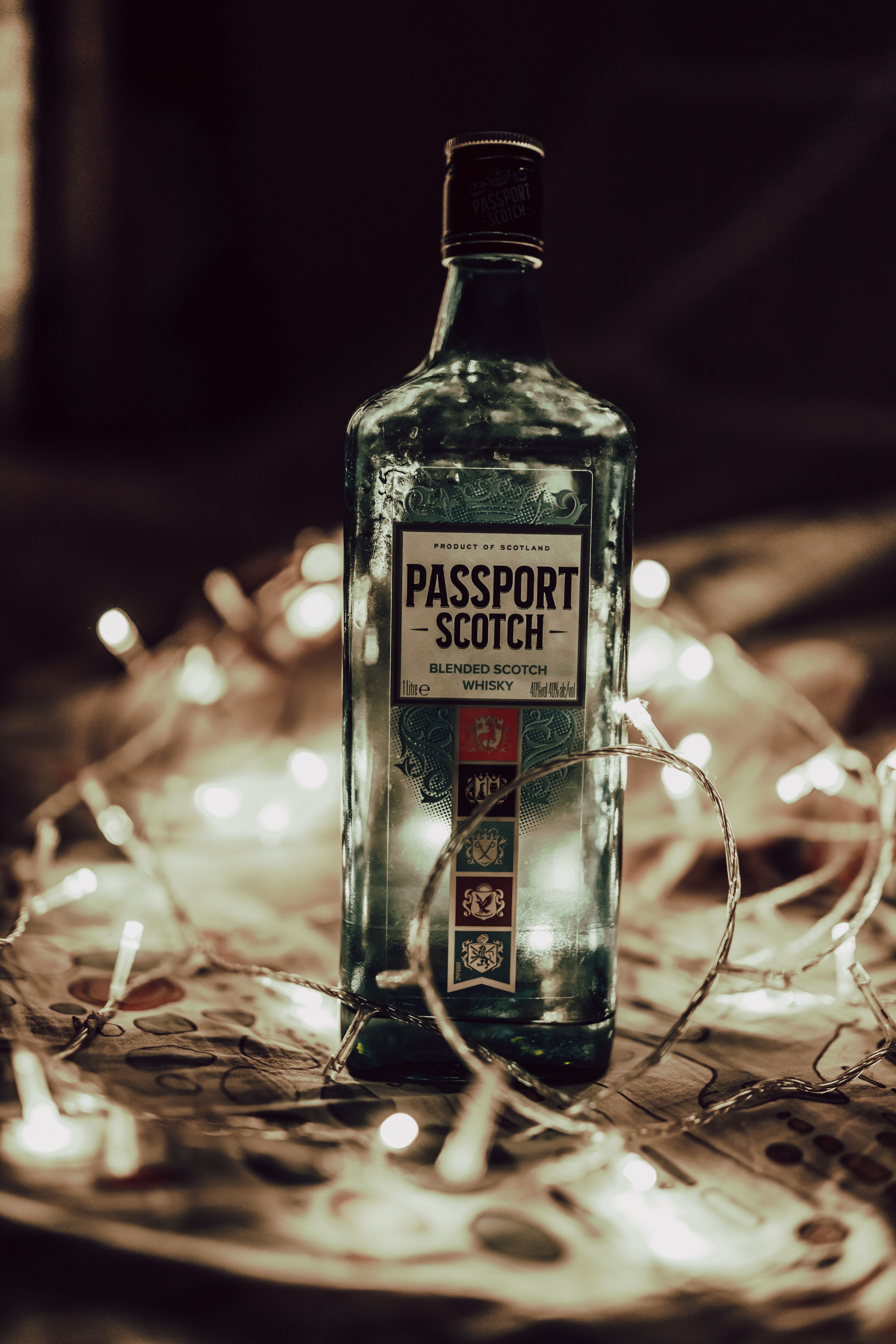 Passport Scotch Bottle with Fairy Lights Display · Free Stock Photo