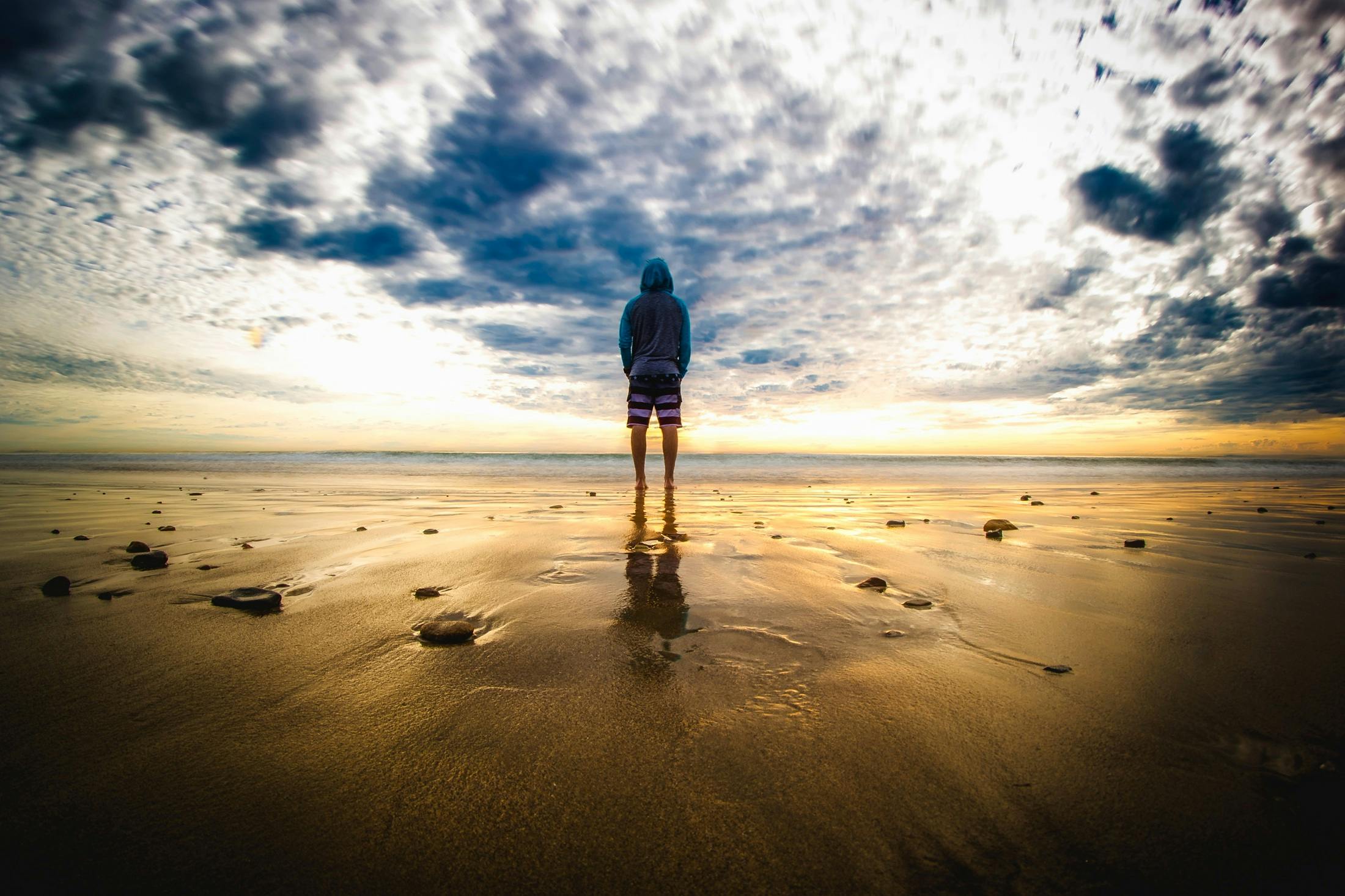 Person Standing on Sand · Free Stock Photo