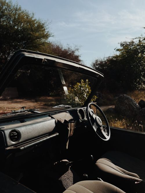 Free Vintage convertible car interior with nature view, sunlight passing through. Stock Photo