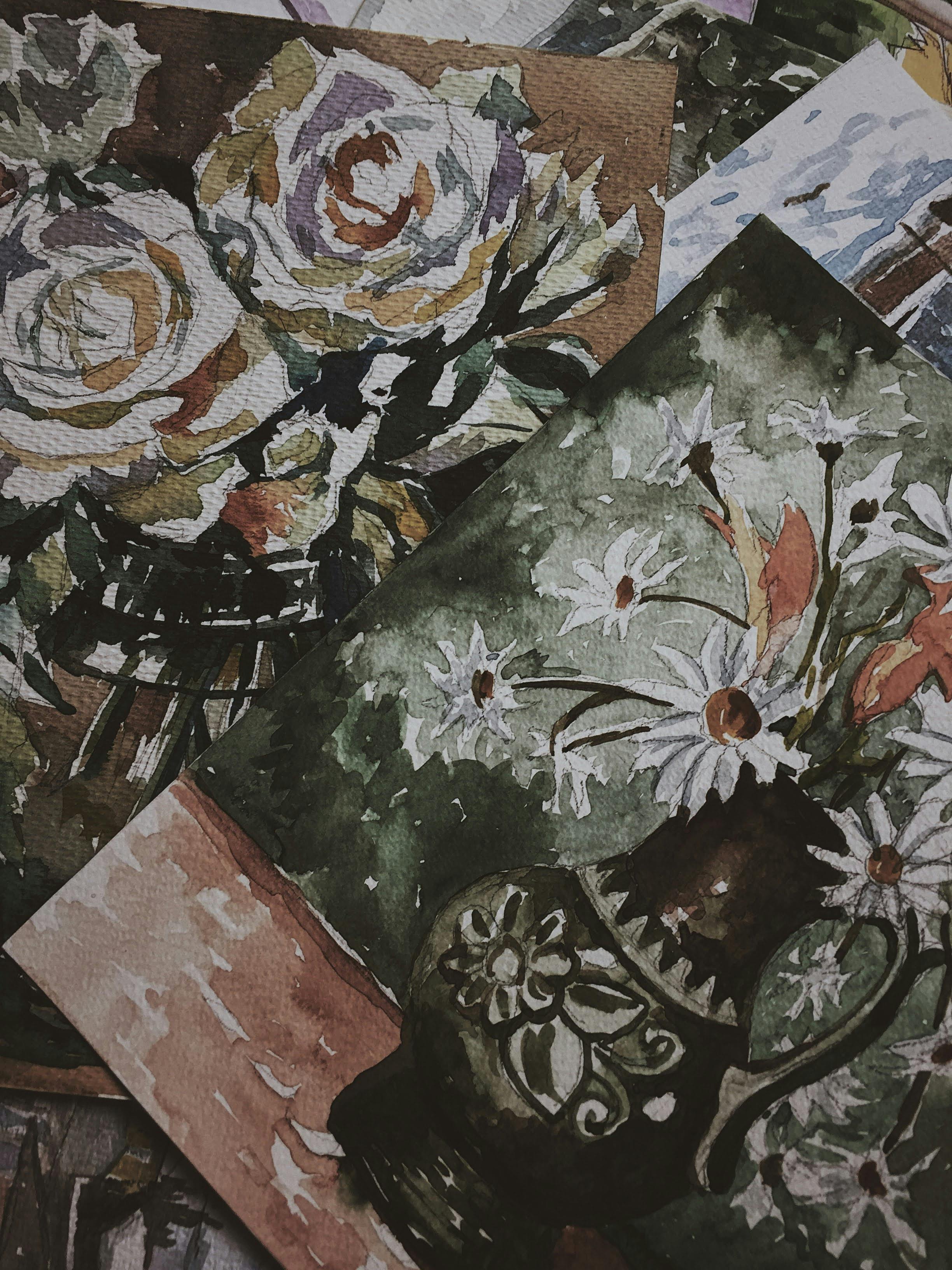 A collection of vibrant watercolor floral paintings displayed on paper showcasing artistic talent.