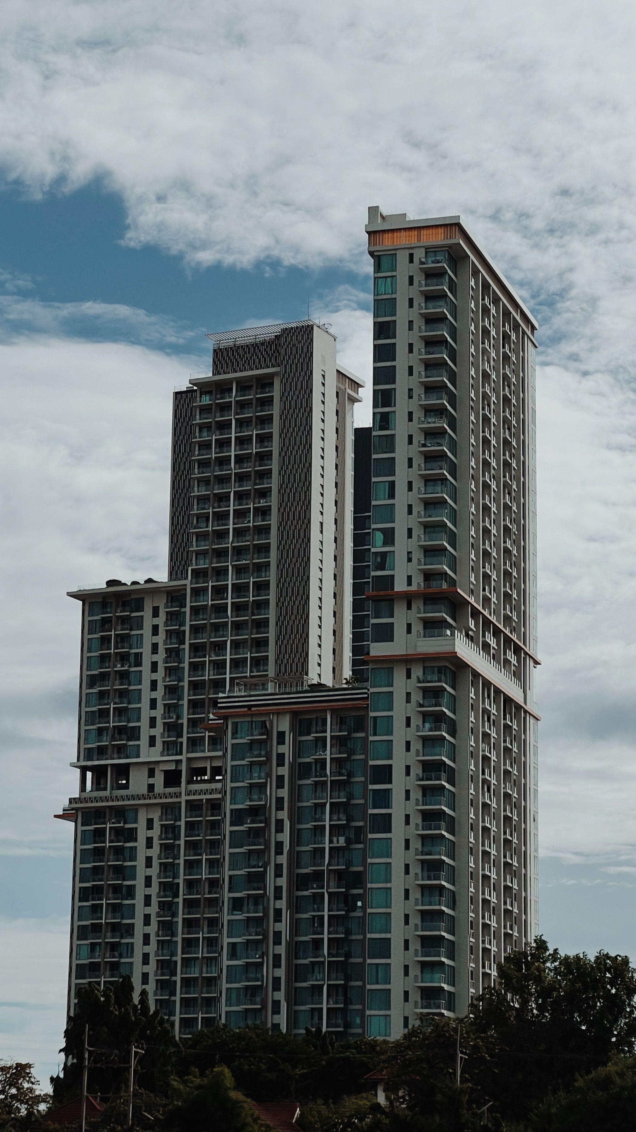 Modern High-Rise Buildings Against Cloudy Sky · Free Stock Photo