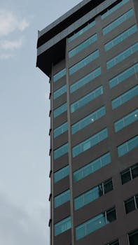 Modern high-rise building captured with a clear sky backdrop. Ideal for urban photography.