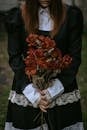 Woman In A Black Dress Oddly Holding A Dry Bouquet of Roses