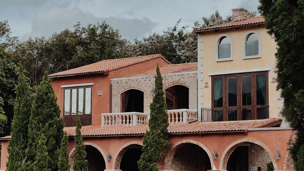 A house surrounded by lush greenery, symbolizing enhanced appeal through property upgrades.