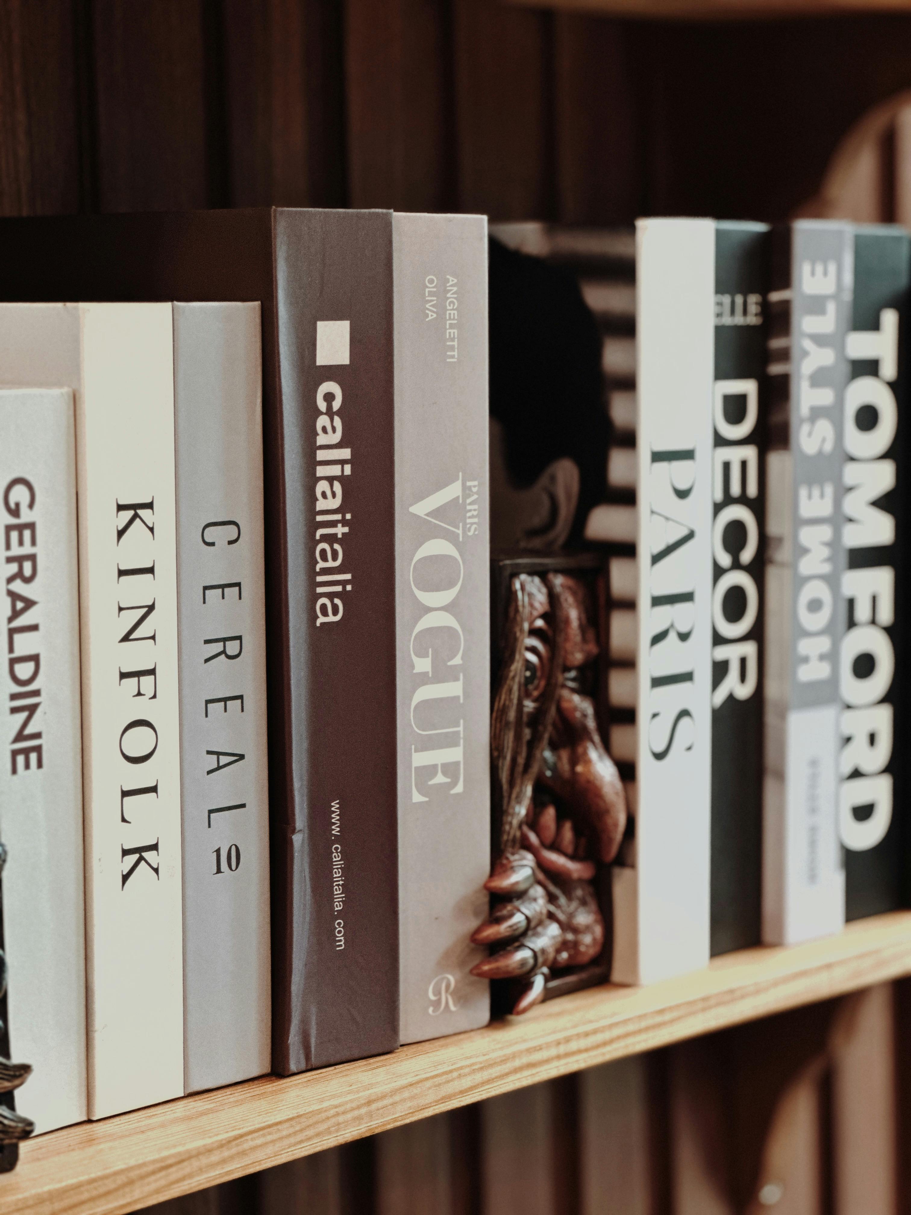 A modern shelf display with a mix of books, art objects, and personal heirlooms.