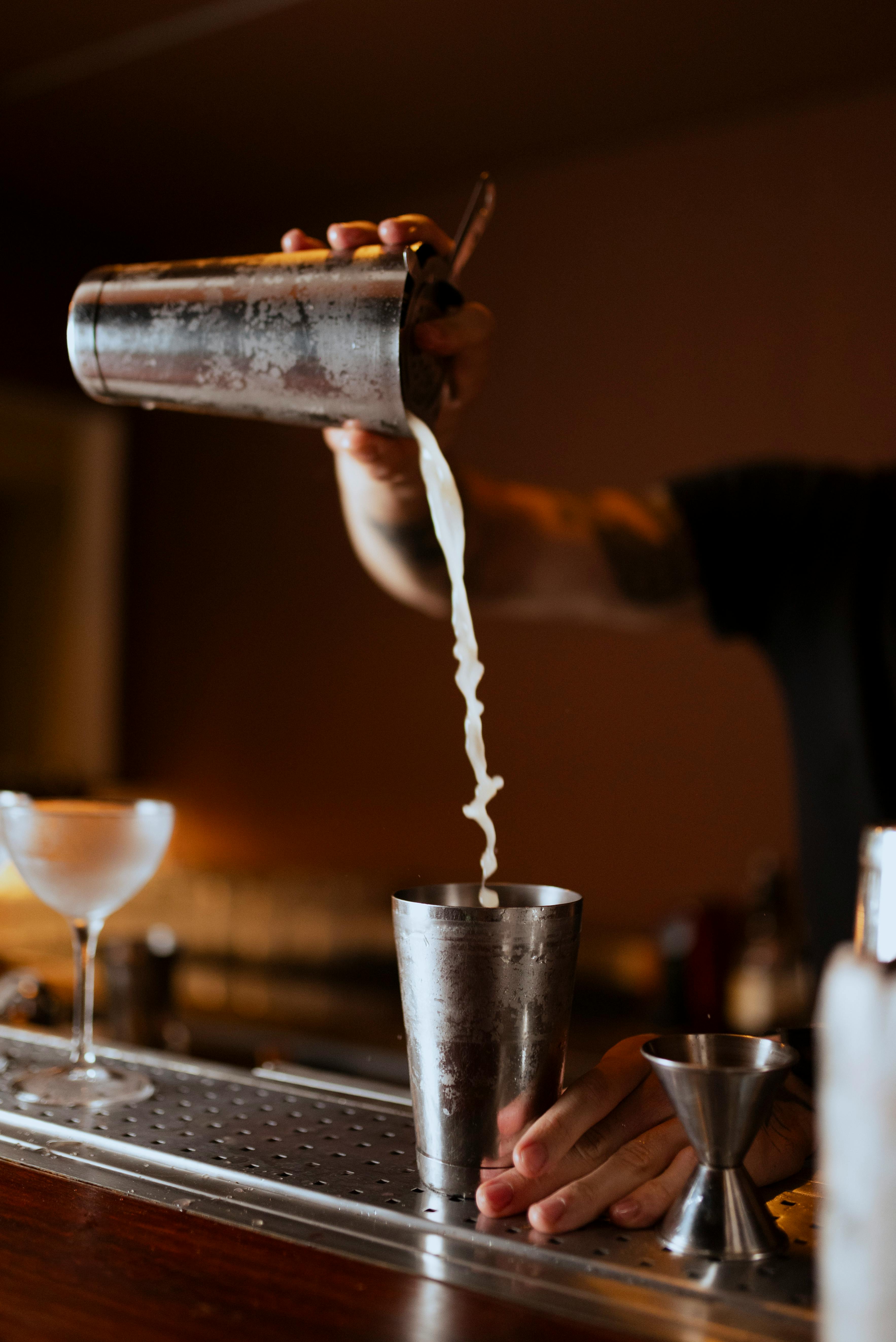 Bartender pouring a cocktail at the bar