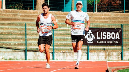 Two Men Running On Track