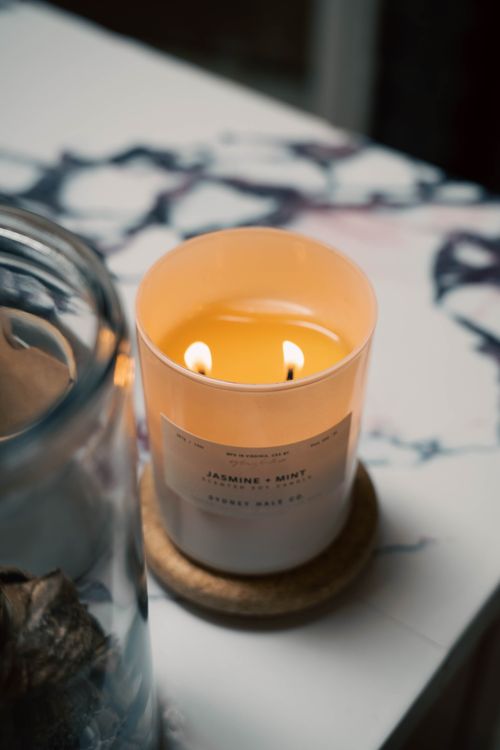 Free A warm jasmine and mint candle creates a relaxing indoor atmosphere. Stock Photo