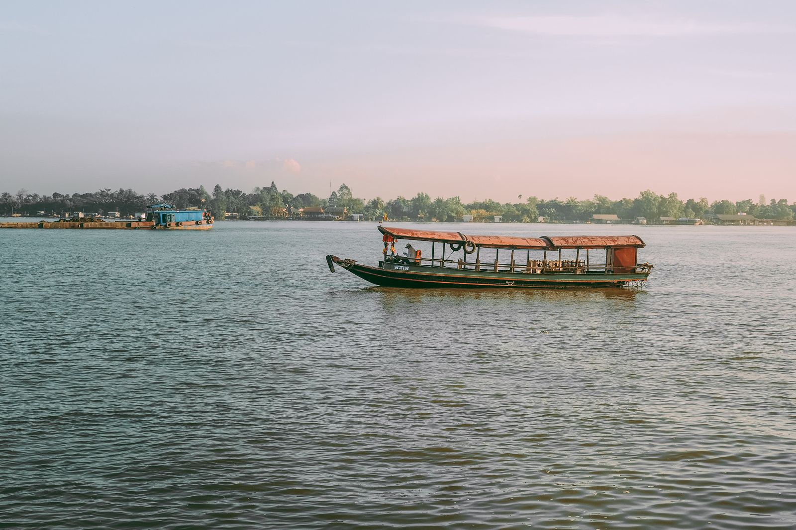 Traditional boat on a calm river at sunset
