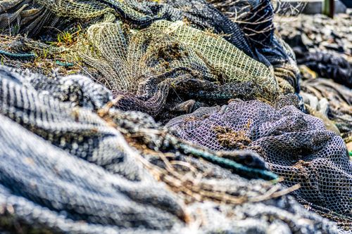 Free Detailed view of intertwined fishing nets with natural textures outdoors. Stock Photo