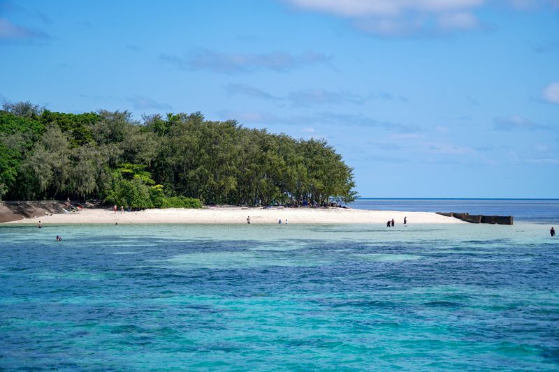 Serene beach with emerald waters and lush greenery on Green Island, Cairns