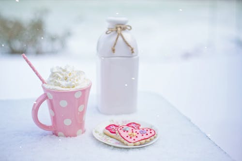 Pink and White Polkadot Ceramic Mug on the Table
