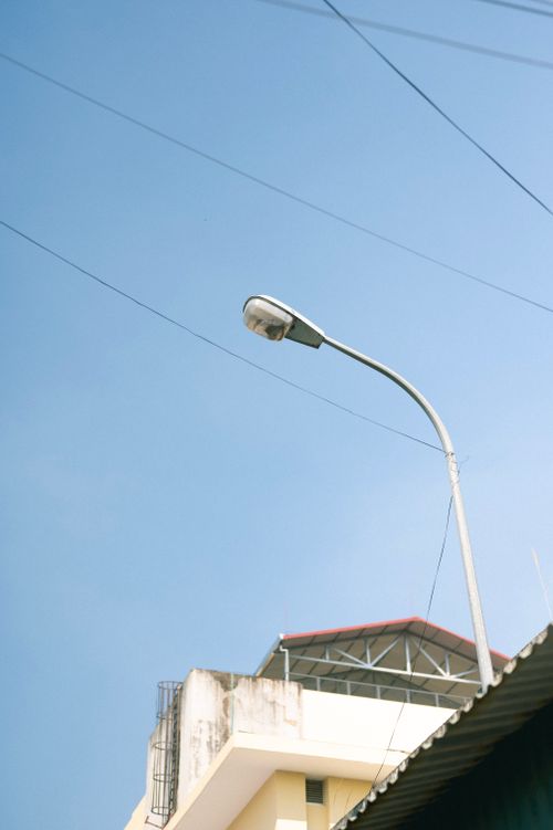 Free A street lamp stands tall against a clear blue sky in Lạng Sơn, Vietnam. Stock Photo