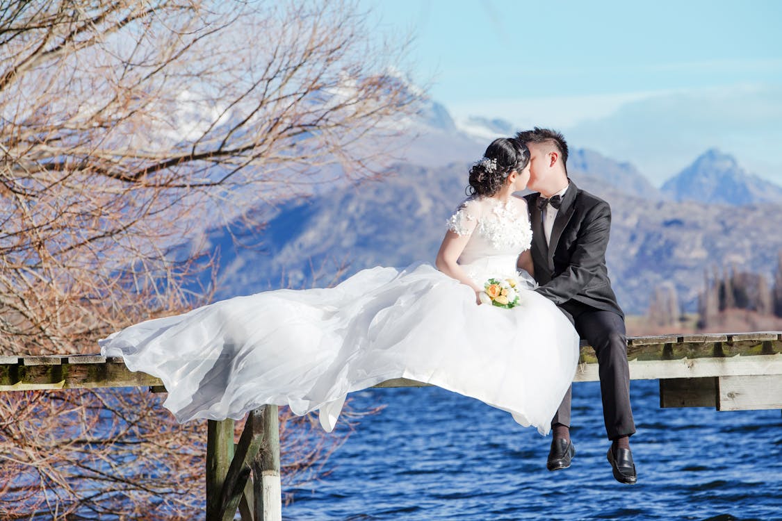 Man and Woman Kissing on Top of Water Dock