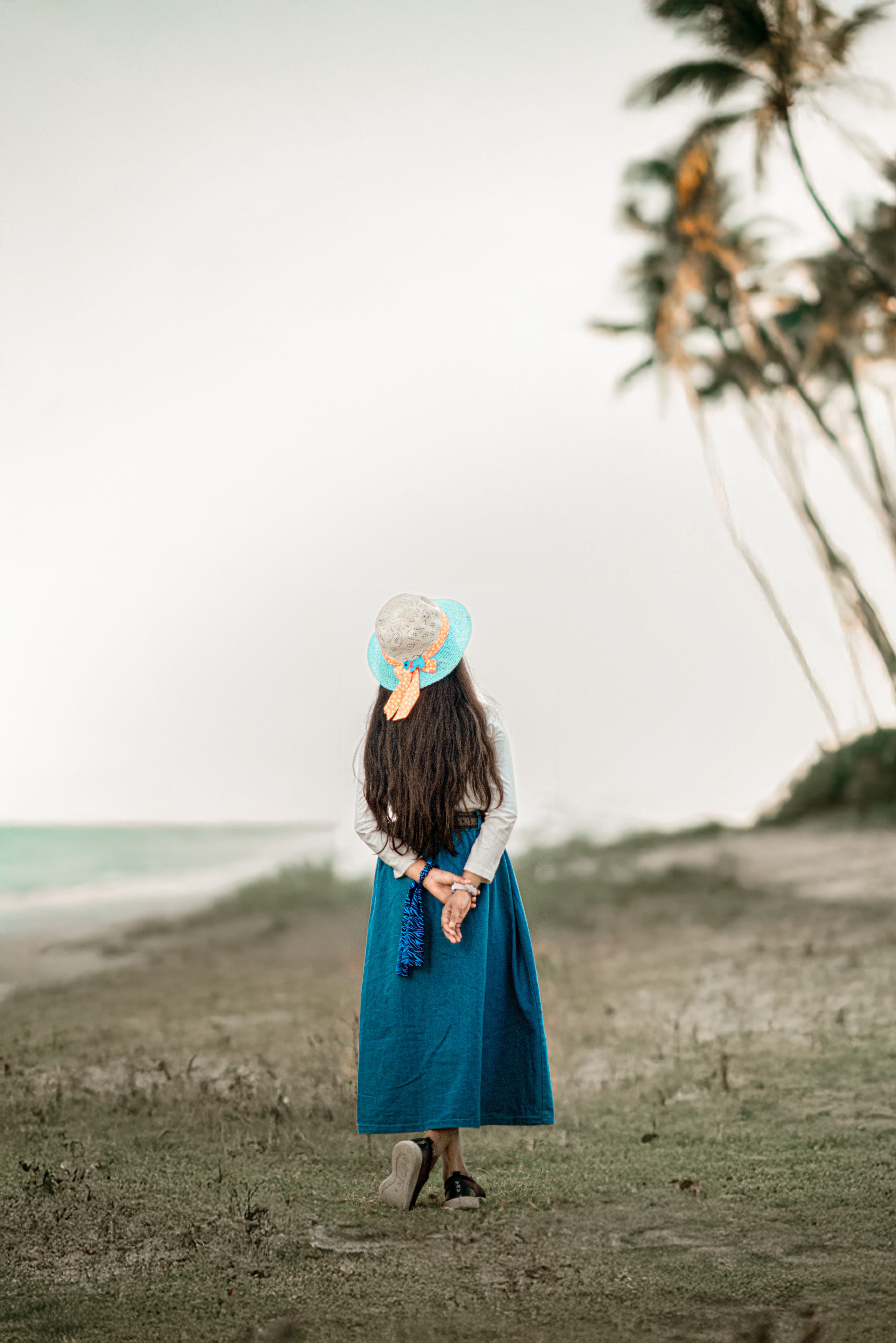 Woman in Blue Dress Strolls on Tropical Beach · Free Stock Photo