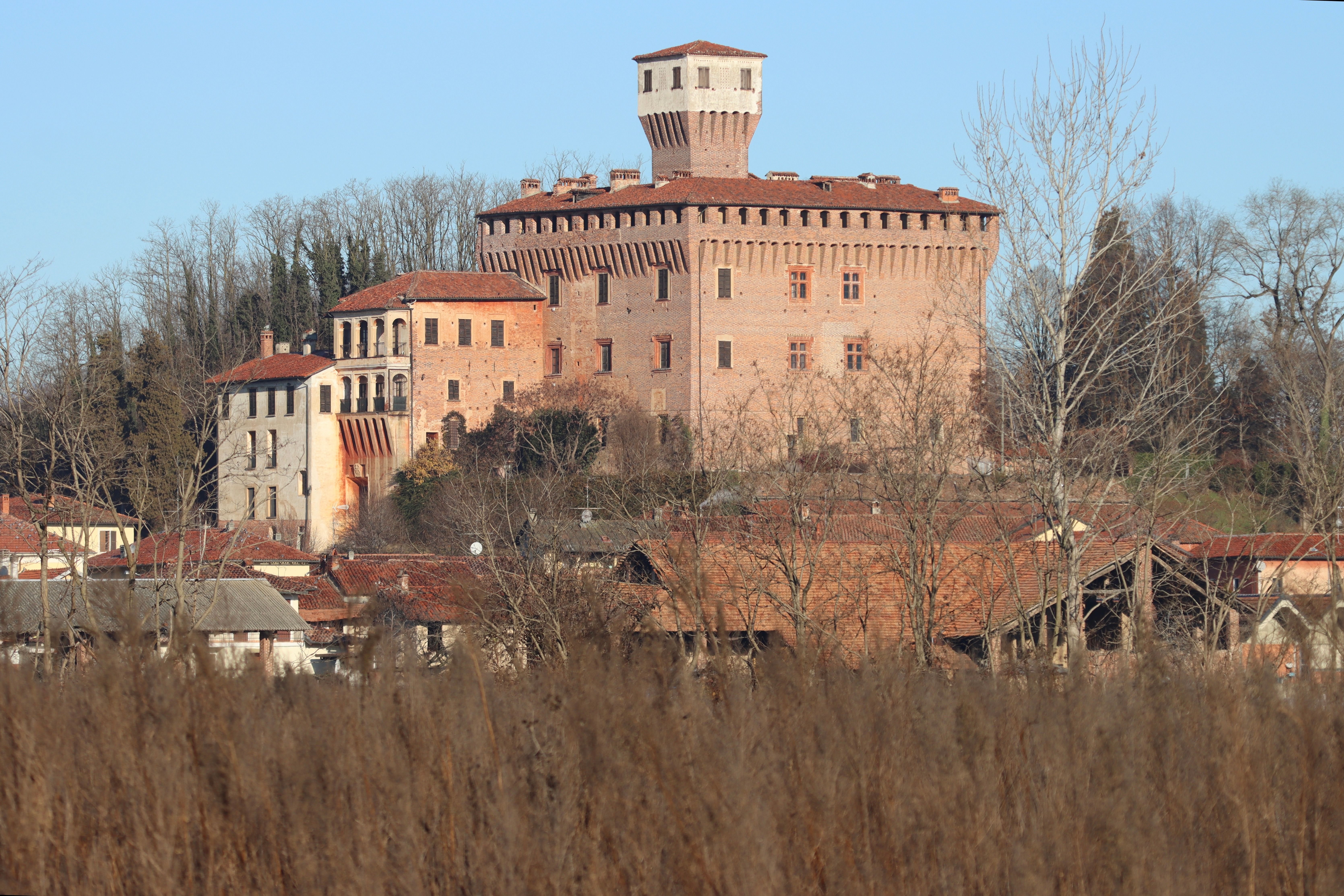 Panoramic view of Briona Castle surrounded by rural landscape in Piemonte, Italy.
