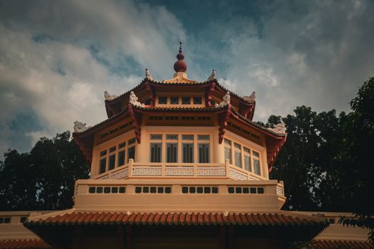 A beautiful traditional Asian building with intricate details under a dramatic sky.