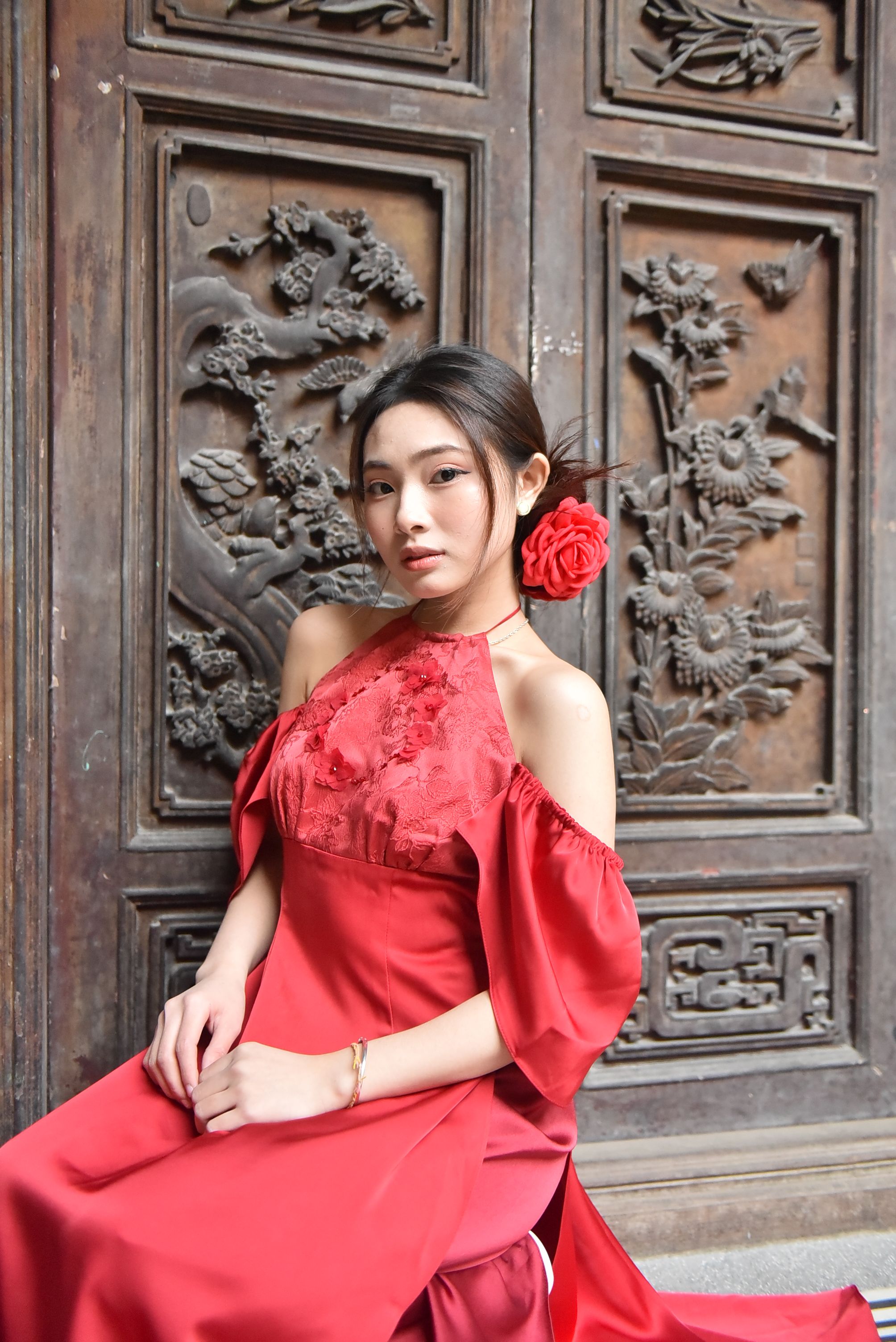 Elegant Woman in Red Dress at Ornate Wooden Door · Free Stock Photo